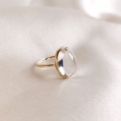 This stunning ring is set in 14k Solid Yellow Gold with Natural Clear Quartz with utmost precision. It is an unique statement gemstone ring for nearly every occasion and is completely hassle-free jewelry. 🔷ABOUT GEMSTONE: Clear quartz, often referred to as the "Master Healer," is a pristine, transparent variety of quartz renowned for its pure energy and versatility. Its crystal clarity represents clarity of mind, and it is believed to amplify the properties of other gemstones. It serves as a po Yellow Gold Moonstone Oval Cabochon Ring Gift, Timeless Yellow Gold Moonstone Ring, Classic 14k Gold Moonstone Ring Gift, Modern Oval Moonstone Ring In Yellow Gold, Modern Oval Yellow Gold Moonstone Ring, Modern Yellow Gold Oval Moonstone Ring, Elegant Gold Crystal Ring With Cabochon, Gift Moonstone Ring In 14k Gold With Oval Cabochon, Polished Yellow Gold Moonstone Ring For Gift