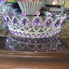 a purple tiara sitting on top of a wooden table