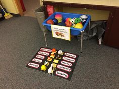 a game set up on the floor in front of a table with cupcakes and doughnuts