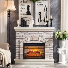 a living room with a fire place and two pictures on the wall above it's mantle