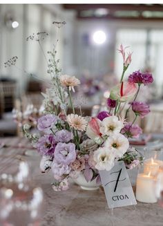 a table with flowers and candles on it