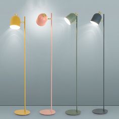 four different colored floor lamps with one light on the top and one on the bottom