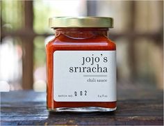 a jar of tomato sauce sitting on top of a wooden table