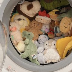 there are many stuffed animals in the washing machine