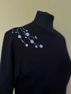 a black shirt with blue flowers on it