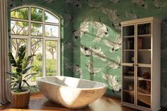 a bathtub sitting on top of a wooden floor next to a book shelf filled with books