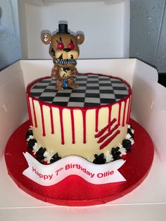 a birthday cake with a teddy bear on top