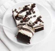 three pieces of cake on a white plate with chocolate chips and marshmallows