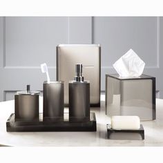 bathroom accessories including soap dispenser, toothbrush holder and tissue dispenser