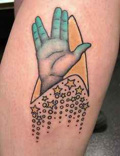 a tattoo on the leg of a person with a hand and stars coming out of it