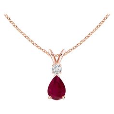 This classic solitaire pendant features a pear-shaped ruby secured in a prong setting. A brilliant round diamond sits atop the purplish red gemstone. Simple yet alluring, this ruby pendant in 18k rose gold is crafted with a lustrous v-bale. Available in different carat weight. Ruby is the Birthstone for July and traditional gift for 15th & 40th wedding anniversaries. Free Certificate of Authenticity. All items are packaged with care in appealing boxes with plush interiors. Ruby Diamond Pendant, Ruby Necklace Pendant, Pearl And Diamond Necklace, Ruby Pendant, Bird Pendant, Red Gemstones, Yellow Gold Setting, E 40, Teardrop Pendant