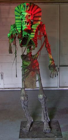 a sculpture of a human being with green and red lights on it's head