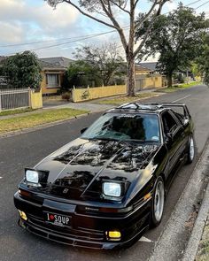 a black sports car parked on the side of the road