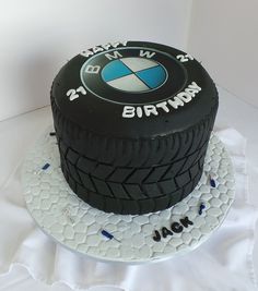 a birthday cake made to look like a car tire with the words bmw on it