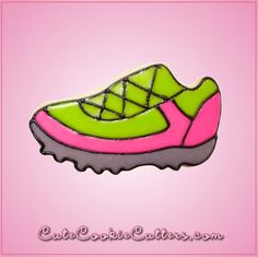 a green and pink shoe with laces on the top, sitting on a pink background