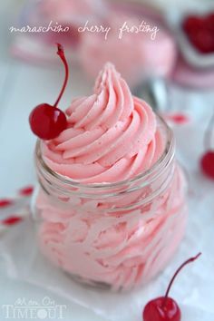 a jar filled with pink whipped cream and cherries