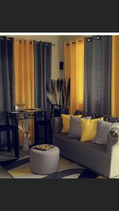 a living room filled with furniture and yellow curtains