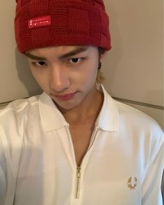 a young man wearing a red hat and white shirt