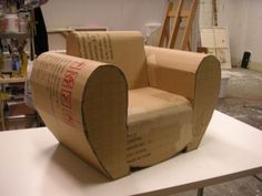 an open cardboard chair sitting on top of a table