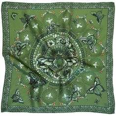 a green bandanna with butterflies on it and an intricate design in the center,