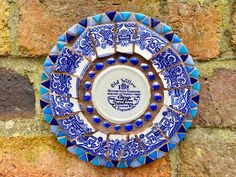 This one off bespoke circular mosaic garden wall plaque is made with willow pattern china. It measures 6.5 x 6.5 inches (17 x 17cms) and is finished with brown grout. It is fully weatherproof and is sure to brighten up any garden wall or indoor living space. It would make a unique gift for someone who loves their garden. This handmade wall art would benefit from being placed where the sunlight catches it so you can see how it sparkles and shines. Although I have taken every care to make sure the Brown Grout, Circular Mosaic, Mothers Day Art, Garden Wall Plaque, China Mosaic, Round Garden, Willow Pattern, Mosaic Garden, Handmade Wall Art