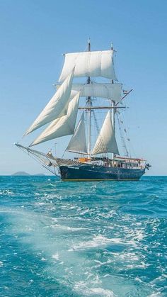 a sailboat sailing in the ocean on a sunny day