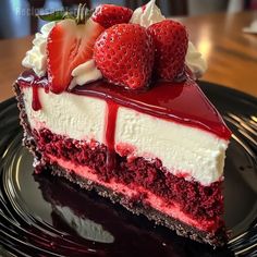 a piece of cheesecake with strawberries on top is sitting on a black plate