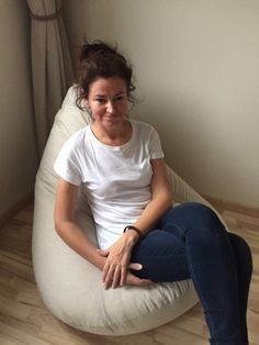 a woman sitting on a bean bag chair