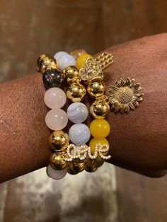 PLEASE MEASURE YOUR WRIST BEFORE ORDERING 🙏🏾 Authentic 10mm Gratitude Goddess Bracelet Stack Made With Yellow Quartz, Clear Quartz, Blue Lace Agate, Gold Marble Howlite, Rose Quartz and Rhodonite Gemstones Yellow Quartz: Creativity, Happiness, Clarity, Joy, Positive Energy (Solar Plexus Chakra) Clear Quartz: Intuition, Clarity, Healing, Amplifies Energy (All Chakras) Blue Lace Agate: Clear Communication, Confidence, Calming (Throat Chakra) Howlite: Tranquillity, Release Trauma, Connect To Higher Consciousness (Crown Chakra) Rose Quartz: Unconditional Love, Peace, Emotional Healing (Heart Chakra) Rhodonite: Compassion, Love, Discover Hidden Talents(Heart Chakra)   ⭐️These bracelets are made-to-order. Sizes are actual wrist circumference, not the length of the bracelet. So please MEASURE Y Spiritual Gold Gemstone Beads, Gold Spiritual Gemstone Beads, Spiritual Hand-strung Beaded Crystal Bracelet, Yellow Spiritual Stretch Bracelet Hand-strung, Spiritual Gold Crystal Bracelet, Hypoallergenic, Goddess Bracelet, Yellow Quartz, Healing Heart, Clear Communication