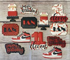 decorated cookies are arranged in the shape of shoes and numbers on a wooden surface with happy birthday written across them