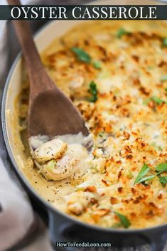 a close up of a casserole in a pan with a wooden spoon