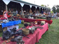 an outdoor flea market with lots of items on the table