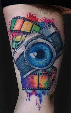 a colorful tattoo with an eye and film strip