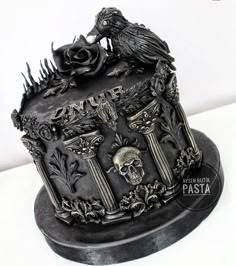 a black cake decorated with skulls and roses