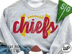 a shirt with the word chiefs on it next to a football and some other items