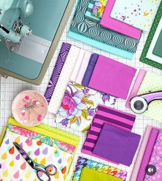 sewing supplies are laid out on a table with scissors and other crafting items in front of them