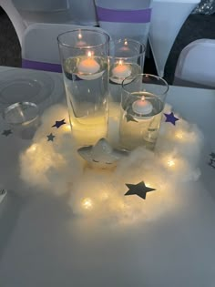 candles are lit in the middle of a cloud with stars on it