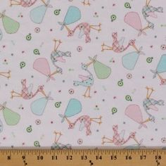 a white background with pink and blue birds on it's side, next to a ruler