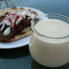 a glass of milk next to a plate with food on it