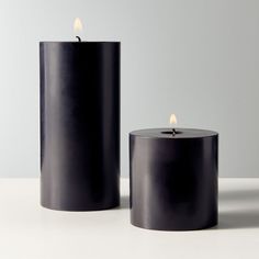 two black candles sitting next to each other