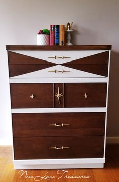 a white and brown dresser sitting on top of a hard wood floor