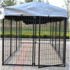 a black dog kennel with a white cover on top