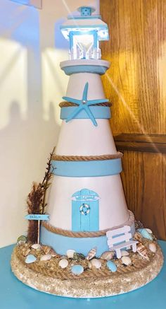 a blue and white tower cake with a starfish decoration on it's top