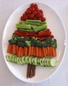 a white plate topped with veggies and carrots on top of each other