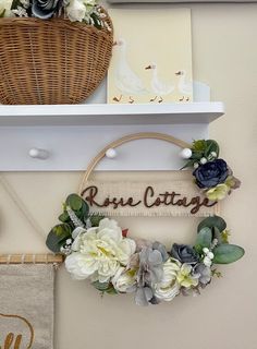 there is a basket with flowers hanging on the wall