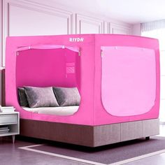 a bed with a pink canopy over it in a room next to a white dresser