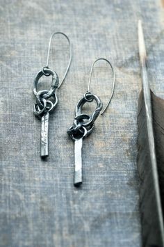 Hand crafted from scratch from 925 sterling silver, these raw dangle earrings combine a rugged, industrial feel with an organic grace provenient from nature. Each of their elements has been carefully handmade, reticulated and further sculpted for deep textures evocative of weathered rocks and fragments of bones  which I find during my walks. The hoops of the ear wires are soldered for safety. The earrings are oxidized and polished lightly. They hang at 7 cm / 2.75 ". Made from solid silver and d Artisan Jewelry Handmade, Unisex Gift, Silver Dangle Earrings, Earrings Unique, Unisex Gifts, Silver Earrings Dangle, Handmade Artisan, Ear Wires, Jewelry Earrings Dangle