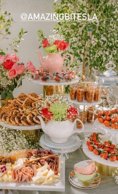 a table topped with lots of desserts and pastries on top of trays