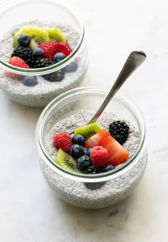 two bowls filled with chia pudding topped with fruit