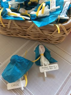 some blue and yellow bags sitting on top of a table next to a brown basket